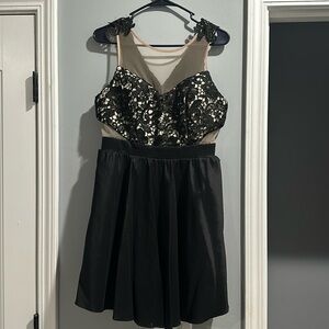 Black cocktail dress, above knee length.